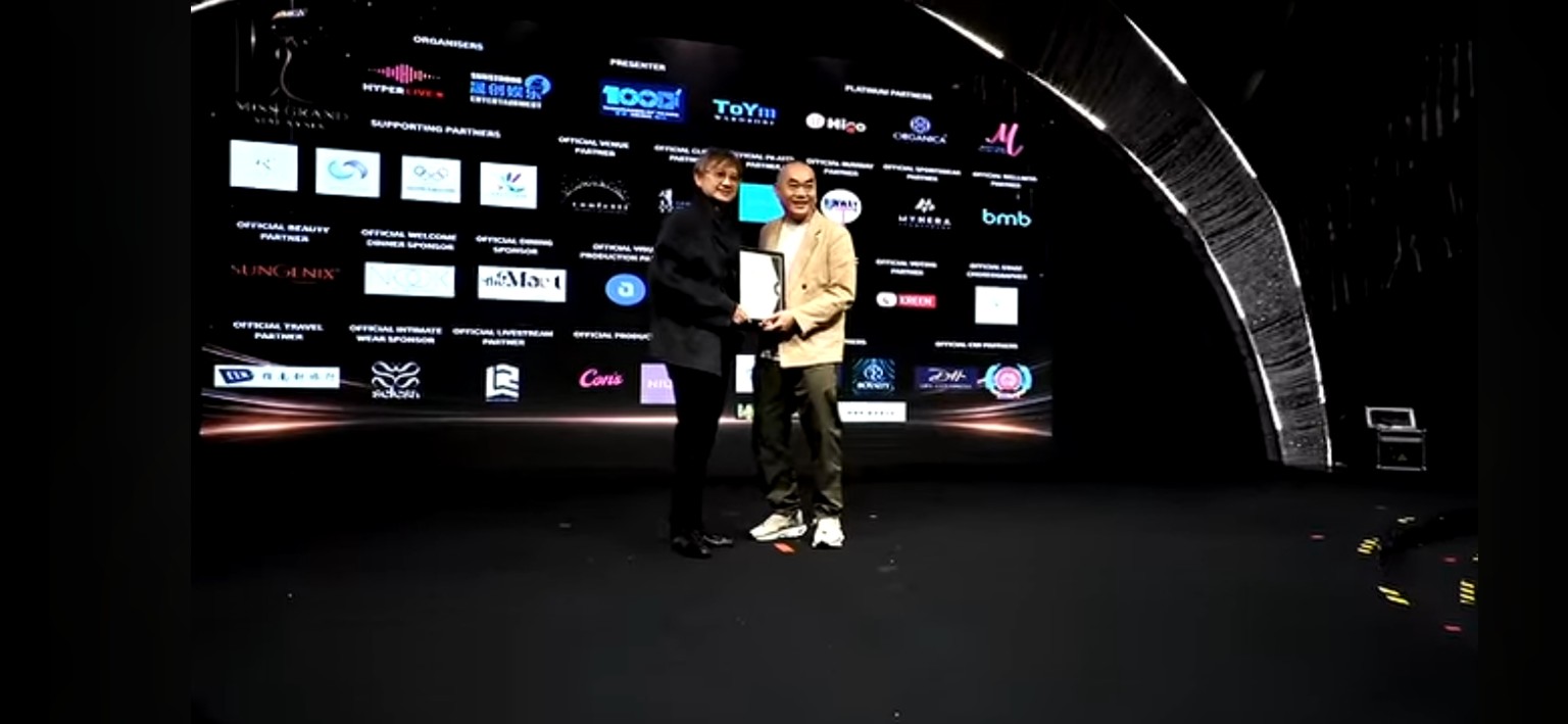Buddy Experience representative receiving recognition on stage at a partner event